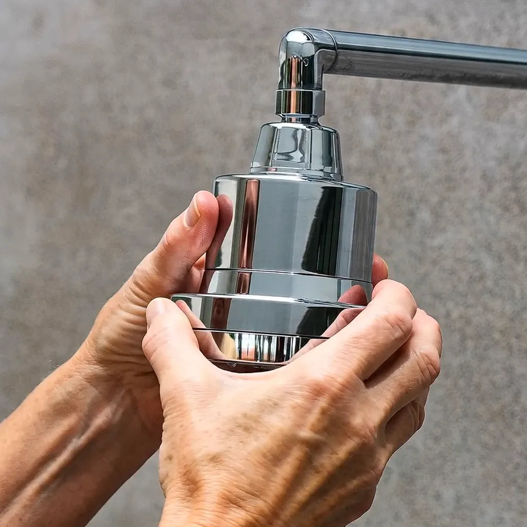 Hands twisting the eskiin showerhead onto a standard shower arm